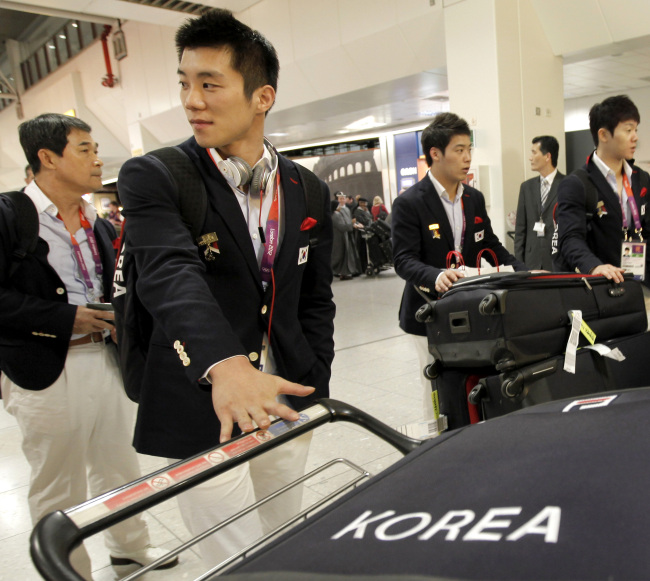 Members of the Korean men’s gymnastics team arrive at Heathrow Airport.  AP-Yonhap News