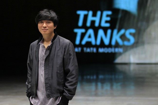 Korean artist Kim Sung-hwan poses for a photograph at the live performance gallery in The Tanks at Tate Modern, London, on Monday.  AP-Yonhap News