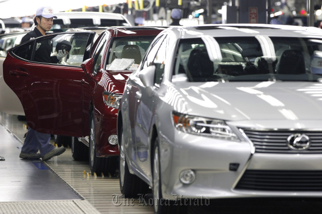 An employee makes a final inspection of a Toyota Motor Corp. Lexus ES sedan on the production line of Toyota Motor Kyushu Inc.’s Miyata plant in Miyawaka City, Japan.  Bloomberg