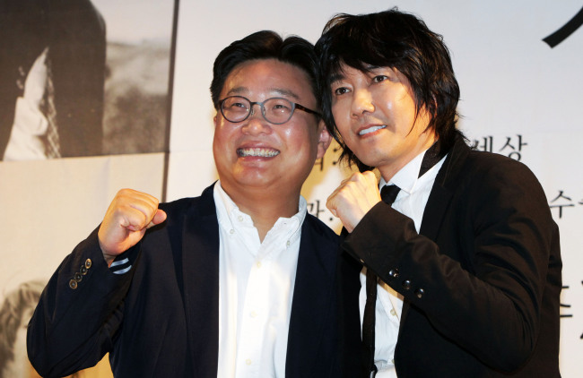 Singer Kim Jang-hoon and Sungshin Women’s University professor Seo Kyoung-duk pose for a photo during a press conference in Seoul, Thursday. Yonhap News