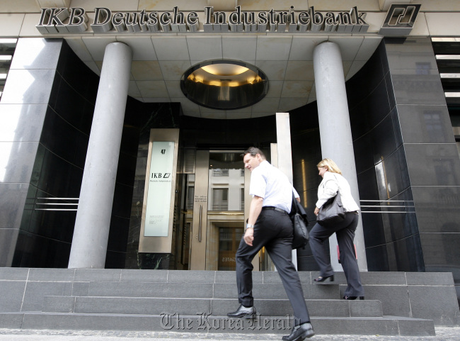 Employees enter an IKB Deutsche Industriebank AG branch in Berlin.  Bloomberg