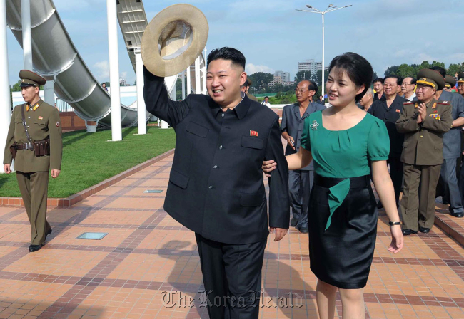 North Korean leader Kim Jong-un (center) and his wife Ri Sol-ju (right) attend the opening ceremony of the Rungna People‘s Pleasure Ground on Rungna Islet along the Taedong River in Pyongyang, Wednesday. (AP-Yonhap News/KCNA via KNS)