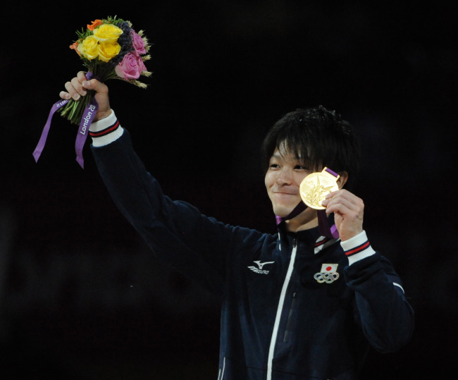 Japan’s Kohei Uchimura celebrates with his gold medal.  UPI-Yonhap News