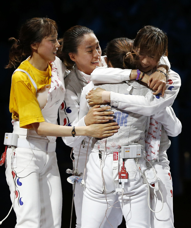 Members of the South Korean foil team celebrate after defeating France during a bronze medal match at women’s team foil fencing at the 2012 Summer Olympics, Thursday.  London Olympic Joint Press Corps