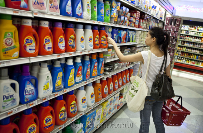 A shopper reaches for Procter & Gamble Co. Tide brand laundry detergent at a supermarket in New York.  Bloomberg