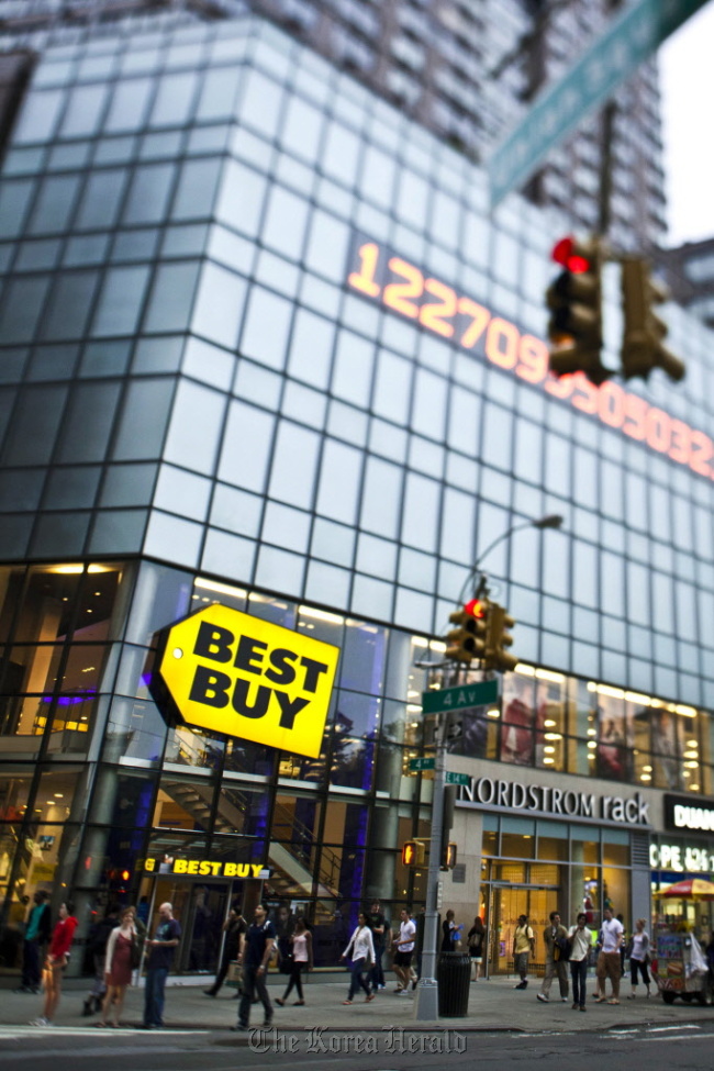 Pedestrians pass in front of a Best Buy Co. store in New York.  Bloomberg