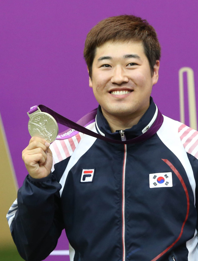 Korean shooter Kim Jong-hyun poses with his silver medal.  London Olympic Joint Press Corps