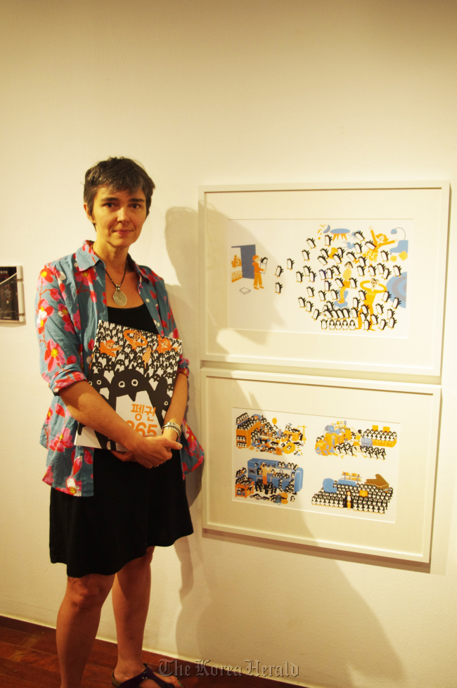 French artist Joelle Jolivet poses next to her illustration at the French illustration exhibition, Sejong Center in Seoul on Tuesday.    Artbus