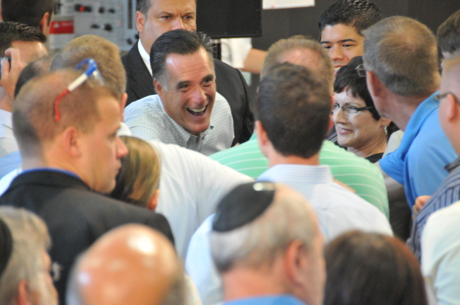 Republican presidential candidate and former Massachusetts Gov. Mitt Romney (center) shakes hands with supporters in a factory at the Elk Grove Village, western suburb of Chicago, Illinois, Tuesday. Xinhua-Yonhap News