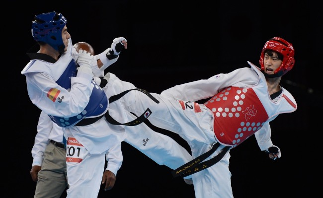 Taekwondo silver-medalist Lee Dae-hoon (right) spars in the final on Wednesday.  London Olympic Joint Press Corps