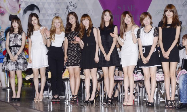 Members of Girls’ Generation pose for photo at a press conference held for S.M. ART Exhibition at COEX, Seoul, on Thursday. Park Hae-mook/The Korea Herald