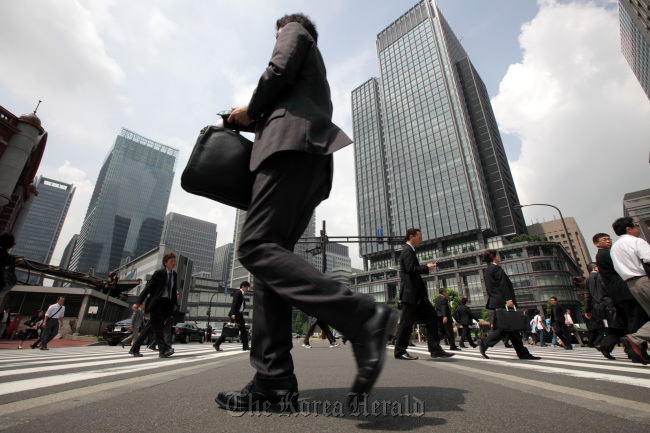 Morning commuters make their way to work in Tokyo.   Bloomberg
