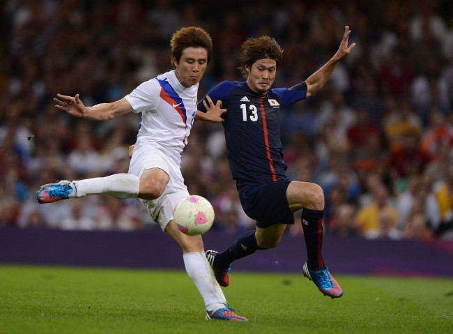 South Korean captain Koo Ja-cheol scores against Japanese defender Daisuke Suzuki. (London Olympic Joint Press Corps)