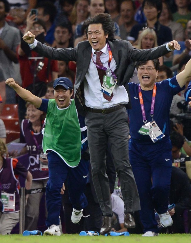 South Korean head coach Hong Myung-bo (center) celebrates after the team's victory over Japan on Friday. (London Olympic Joint Press Corps)