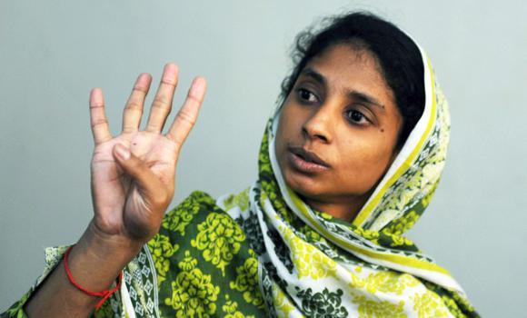 Geeta, a deaf and mute Indian girl, communicating her story through her own form of sign language during an interview at a charity in Karachi.   AFP