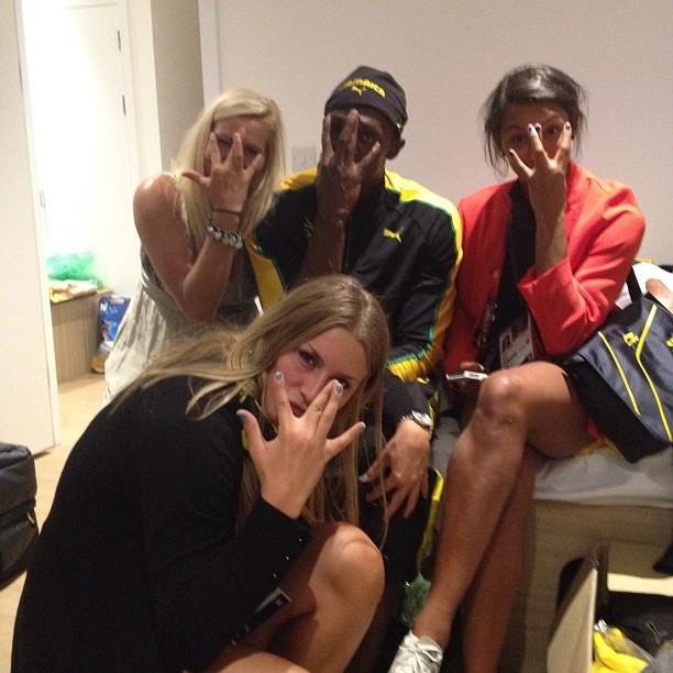 Usain Bolt poses with three Swedish female athletes in his bedroom (Twitter)