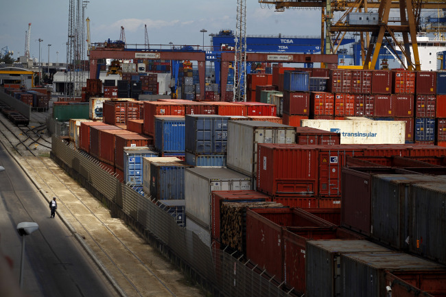 A man walks near containers at the port in Lisbon on Tuesday.   AP-Yonhap News