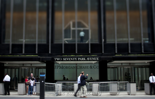 Pedestrians pass in front of the JPMorgan Chase & Co. headquarters in New York.    Bloomberg