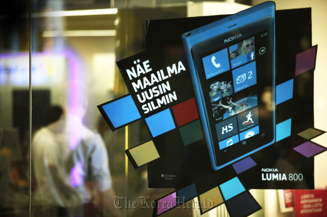 An advertisement for the Nokia Lumia 800 is displayed at a mobile phone store in Helsinki, Finland.   Bloomberg