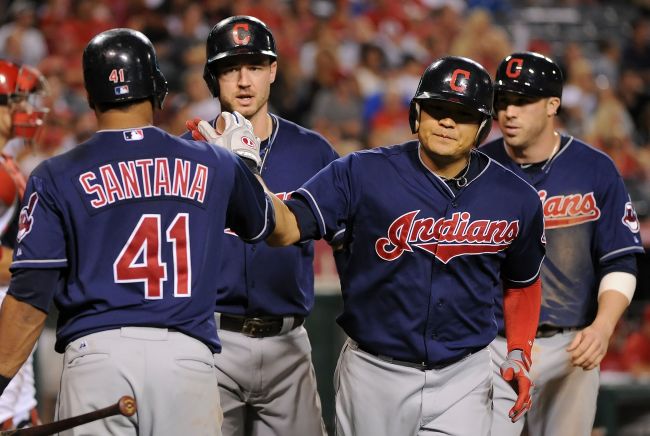 Indians outfielder Choo Shin-soo (second from right) celebrates with teammates after hitting a three-run homer in the eighth inning.   AFP-Yonhap News