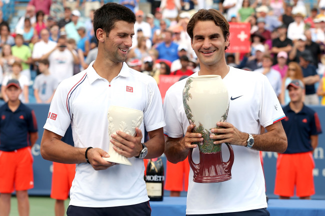 Novak Djokovic (left) and Roger Federer pose with their trophies on Sunday.   AFP-Yonhap News