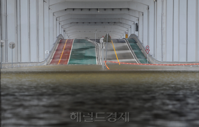 서울 지역 폭우로 교통과 보행이 모두 통제된 21일 서울 잠수교.<br />이상섭 기자 babtong@heraldm.com 2012.08.21
서울 지역 폭우로 교통과 보행이 모두 통제된 21일 서울 잠수교.
이상섭 기자 babtong@heraldm.com 2012.08.21
장마기간도 아닌데 8월에 많은 비가 서울, 경기, 강원권에 쏟아졌다. 서울에서는 청계천 이동이 금지됐다. 잠수교는 물에 잠겨 사람도, 차량도 이동이 통제됐다. 큰 비 피해가 있지는 않았다. 이번 비는 22일 오후께 그칠 것으로 보인다. 21일 오전 통제된 잠수교의 모습이다.  이상섭 기자/babtong@