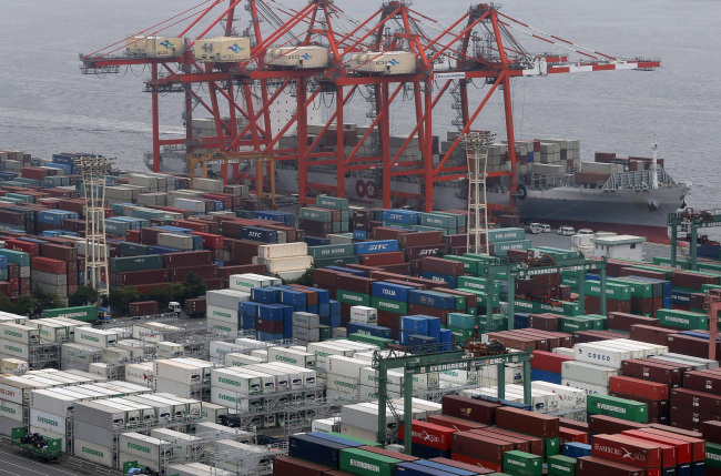 Containers pack a container terminal at a pier in Tokyo.    AP-Yonhap News