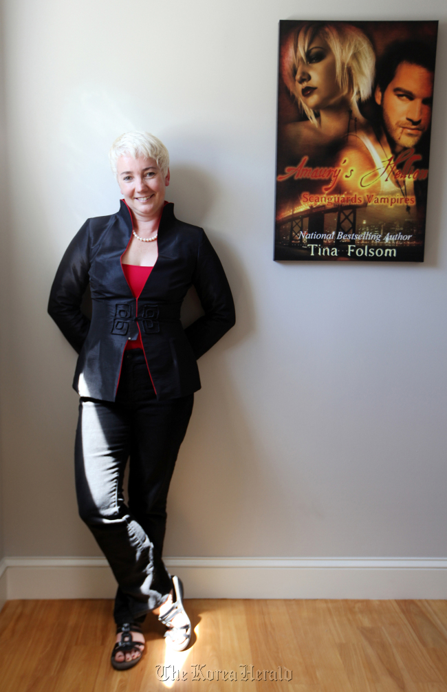 Self-published writer Tina Folsom is photographed in her home where many of her novel covers hang on her walls in San Francisco, California, on Aug. 6.   Contra Costa Times/MCT