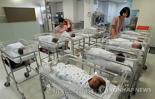 Nurses take care of newborns at a hospital in Seoul.   Yonhap News