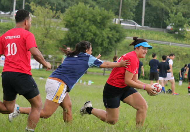 Pauline Stokes, of the Island Stylez touch team seeks to evade Tara Tasi’s tackle. Erik Sorenson