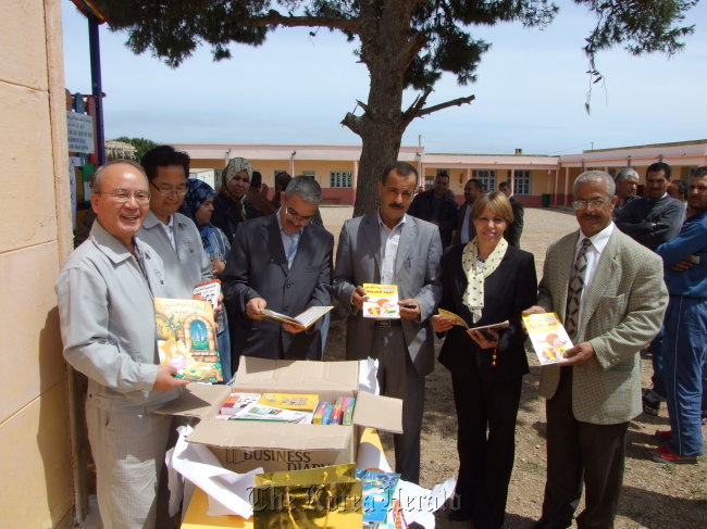 Officials from Daewoo Engineering and Construction pose with local community officials after donating books to a school in Hassasna, Algeria.   Daewoo E&C