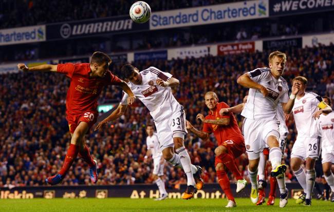 Liverpool forward Adam Morgan (left) heads on goal during the Europa League qualifying match against Hearts at Anfield on Thursday.    AFP-Yonhap News