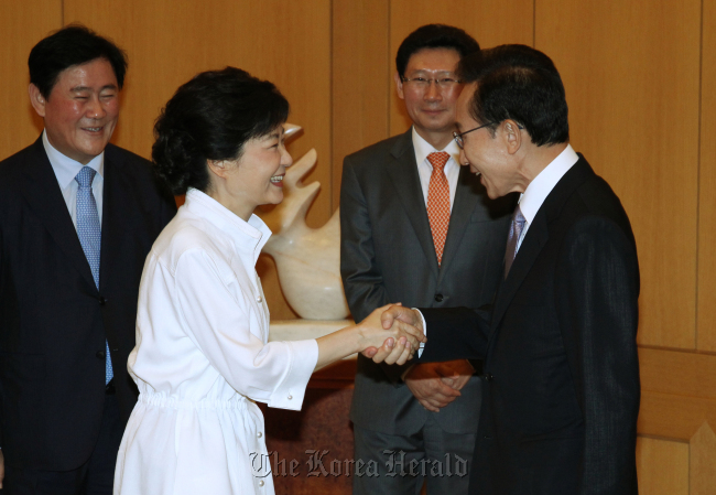President Lee Myung-bak (right) and Rep. Park Geun-hye shake hands as they meet for a one-on-one luncheon meeting at Cheong Wa Dae on Sunday.   Chung Hee-cho/The Korea Herald