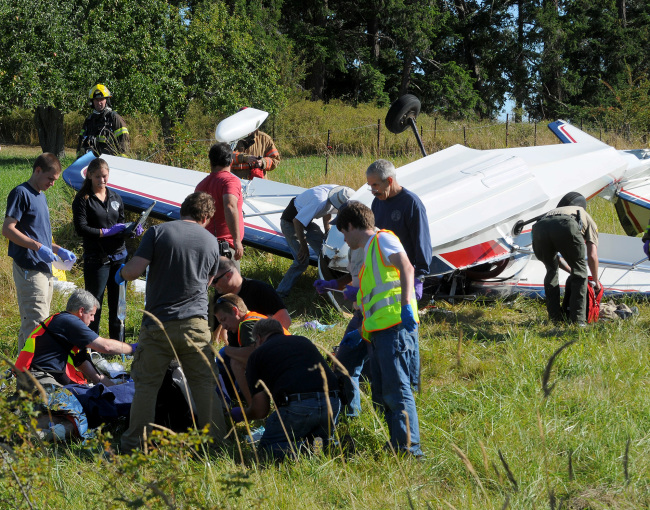 Emergency personnel attend to pilot Richard Bach after Bach’s plane crashed in a field, in Friday Harbor, Washington, Friday.   AP-Yonhap News