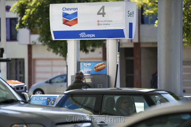 A customer buys fuel at a Chevron Corp. gasoline station in San Francisco, California.   Bloomberg