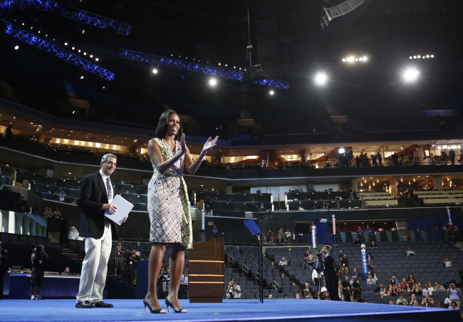 First Lady Michelle Obama gestures as she appears at the podium for a camera test on the stage at the Democratic National Convention inside Time Warner Cable Arena in Charlotte, N.C., on Monday. (AP-Yonhap News)