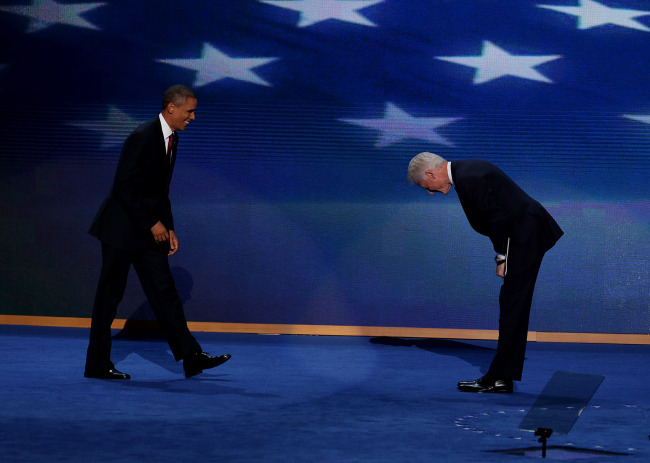U.S President Barack Obama (left) smiles while arriving on stage as former U.S. President Bill Clinton bows during day two of the Democratic National Convention in Charlotte, North Carolina, Wednesday.   Bloomberg