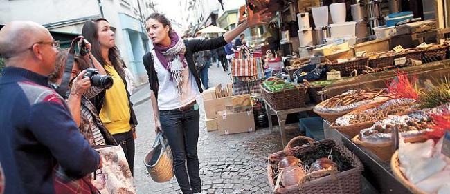 Visitors of the Fête de la Gastronomie international food festival in France tour a grocery store during its tour program. (Atout France)