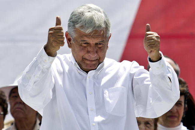 Andres Manuel Lopez Obrador, former presidential candidate of the Democratic Revolution Party, gives a thumbs up to his supporters at Mexico City’s main plaza, the Zocalo, Sunday.   AP-Yonhap News