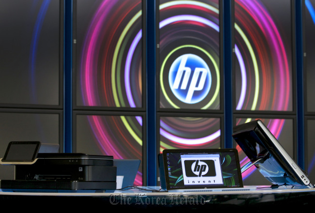 Hewlett-Packard Co. printers and computers sit on display in the lobby at the company’s headquarters in Palo Alto, California.   Bloomberg