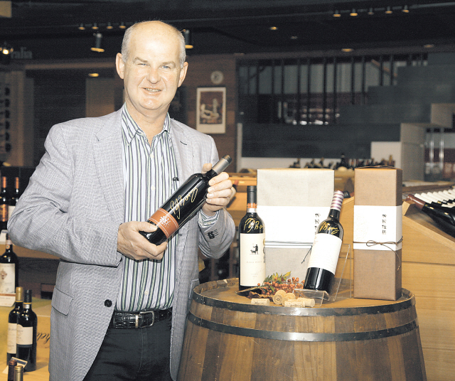 Peter Barry, managing director and proprietor of Jim Barry Wines, poses with the company’s products in Seoul.(Nara Cellar)