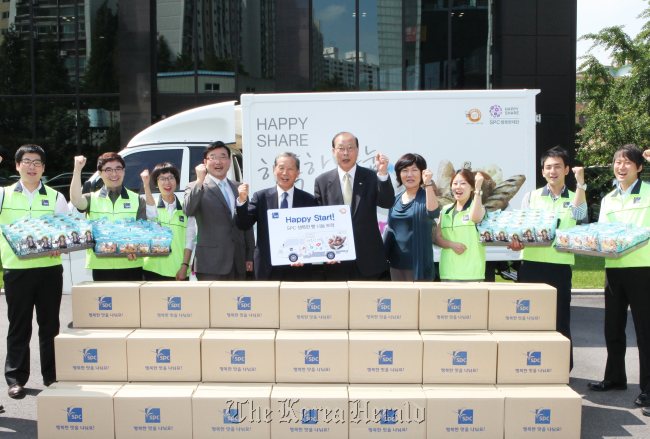 SPC executives and employees attend a ceremony to deliver bread to social welfare centers and rural areas this month.   SPC