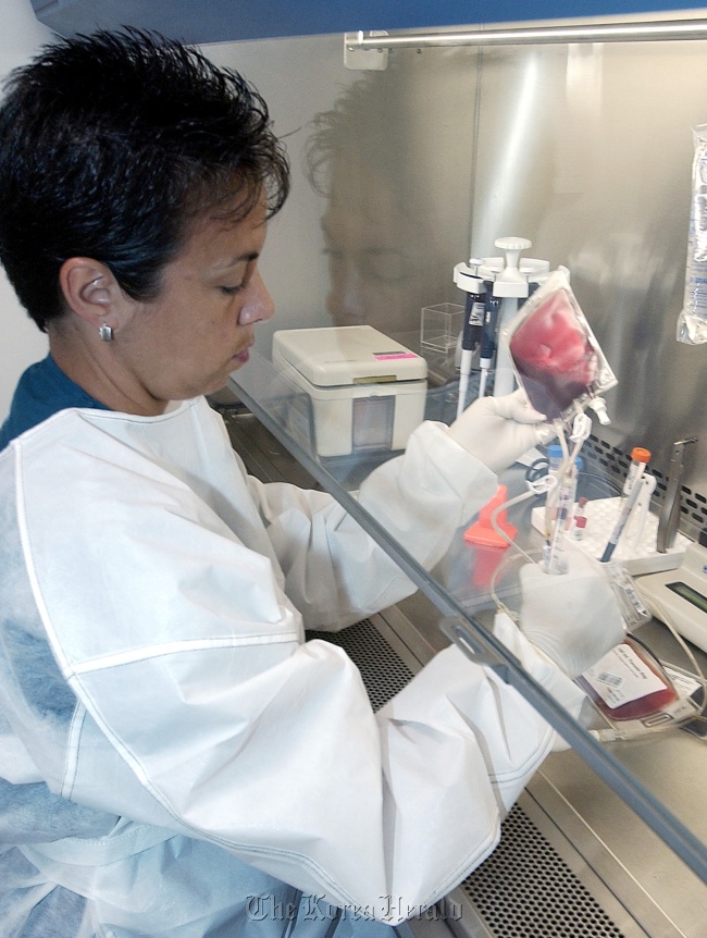 A technician processes umbilical cord blood.   MCT