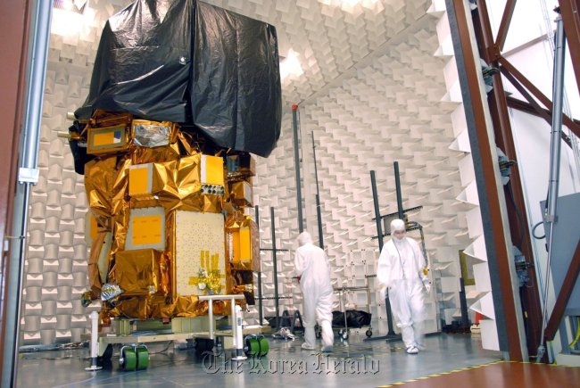This Aug. 7 photo provided by NASA shows the next Landsat imaging satellite during testing at the Orbital Science Corporation’s facility in Gilbert, Arizona.   NASA