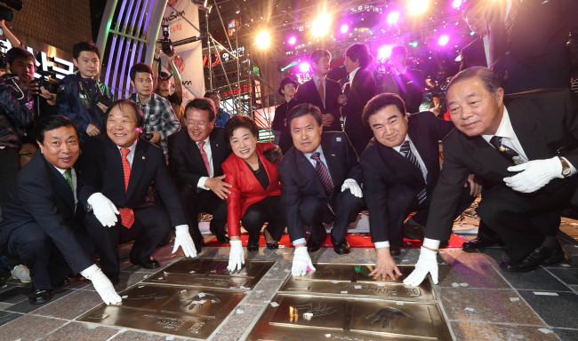 Busan mayor Hur Nam-sik (third from right) poses with his guests during a special ceremony unveiling the newly created hand prints of renowned cineastes, including Korean director Kim Ki-duk, French director Luc Besson, and French actress Isabelle Huppert, at BIFF Plaza in Busan, on Wednesday.    Yonhap News