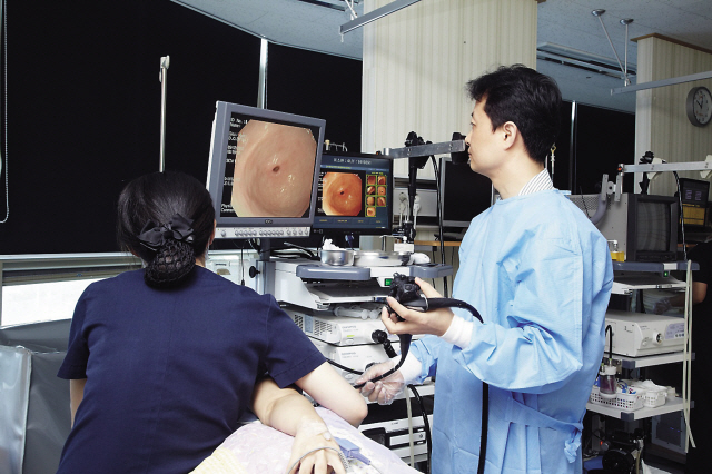 A doctor performs a gastroscopy to examine a patient’s upper digestive system. (On Hospital)