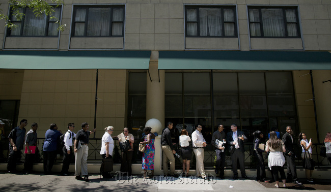 Job seekers wait in line to enter a Choice Career Fair in New York.   Bloomberg