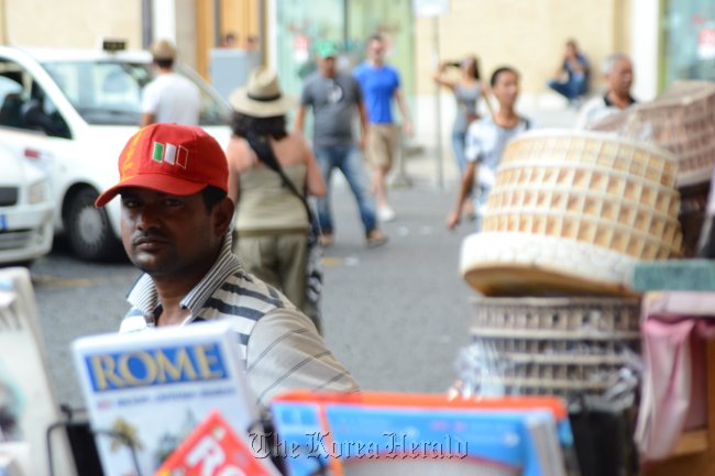 Educated Bangladeshis find themselves selling tourist merchandise in big cities like Rome as the economic crisis means there are fewer better-paid jobs. The Daily Star