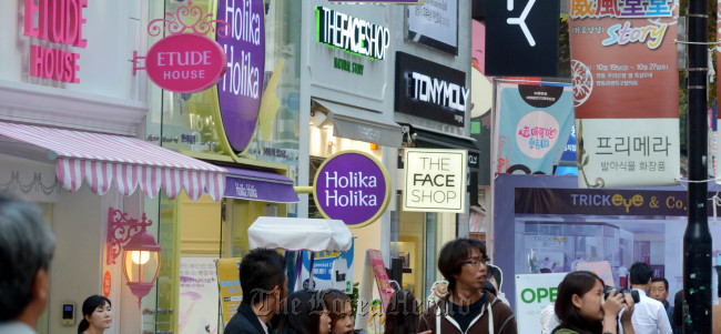 A street in central Seoul is crowded with signboards in foreign languages.   Kim Myung-sub/The Korea Herald
