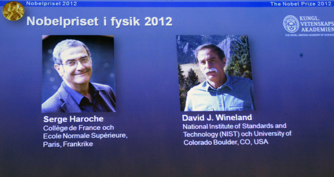 Photographs of the 2012 Nobel Prize laureates in Physics Serge Haroche from France, left, and David Wineland from the US are presented on a screen during a media conference at the Royal Swedish Academy of Science in Stockholm, Sweden, Tuesday Oct. 9, 2012. (AP-Yonhap News)